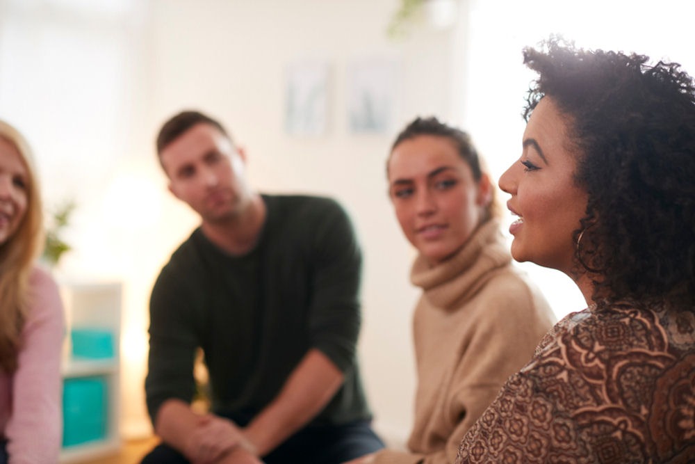 group listening to woman share her experience