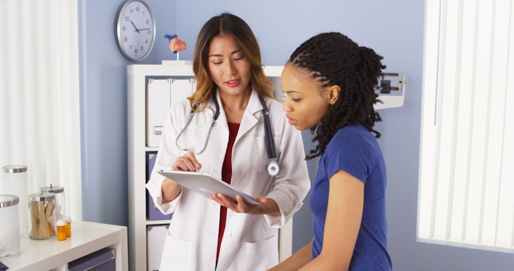 doctor explaining treatment to female patient