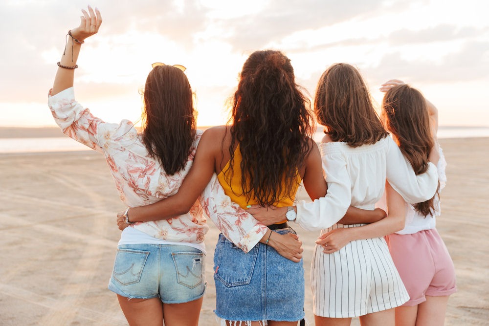 group of women standing on beach