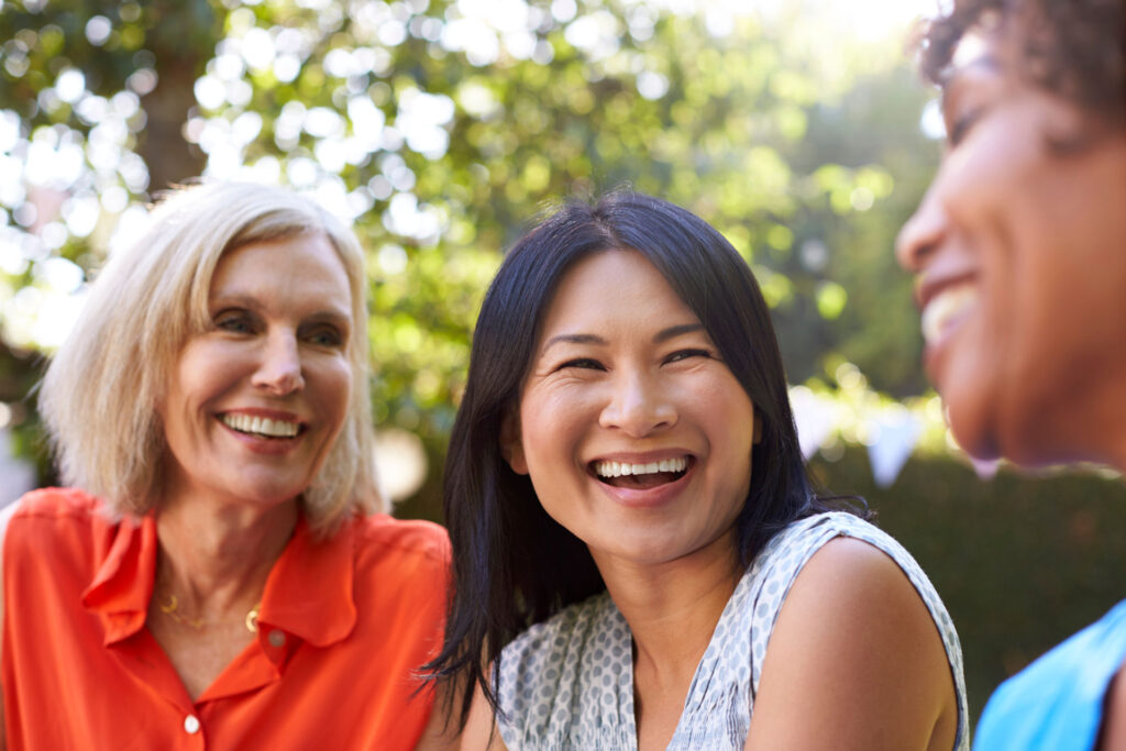 three women smiling and laughing together