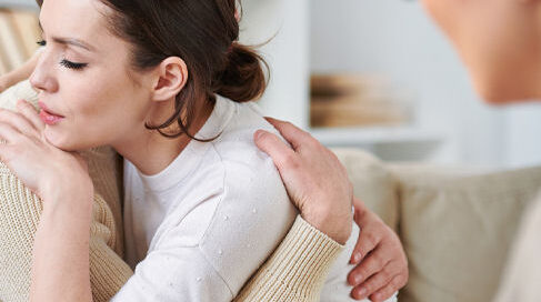 People hugging during drug rehab group therapy